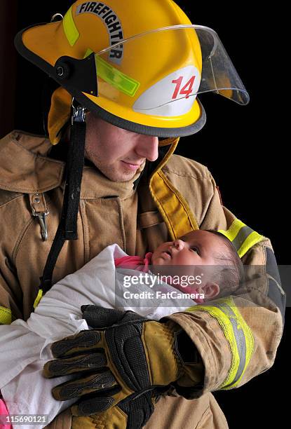 fireman'e baby - firefighters foto e immagini stock