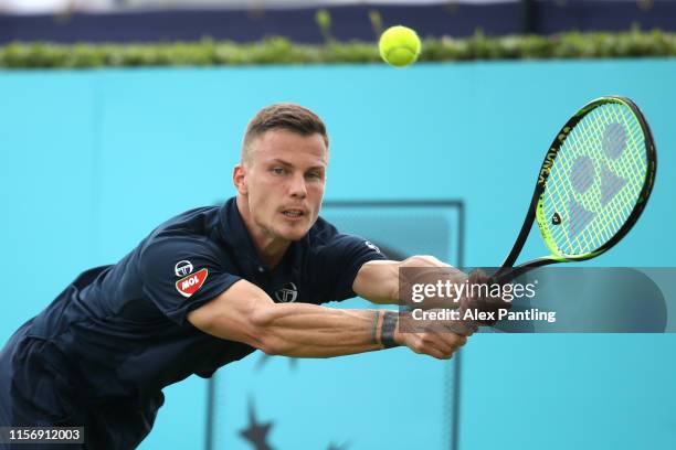 Marton Fucsovics of Hungary plays a backhand during his First Round Singles Match against Feliciano Lopez of Spain during day Three of the Fever-Tree...