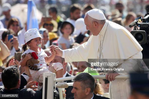 Pope Francis greets a baby as he arrives in St. Peter's square for his weekly general audience on June 19, 2019 in Vatican City, Vatican.