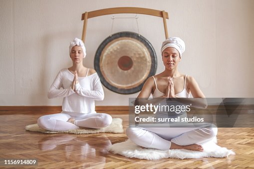 Two beautiful females doing kundalini yoga Two beautiful females doing kundalini yoga