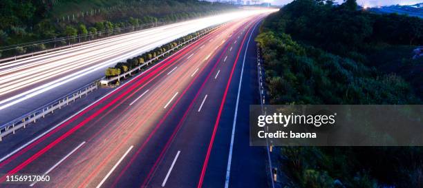 highway fast traffic at night,  long time exposure - winding road night stock pictures, royalty-free photos & images