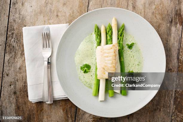 green and white asparagus with cod. - cooked asparagus stock pictures, royalty-free photos & images