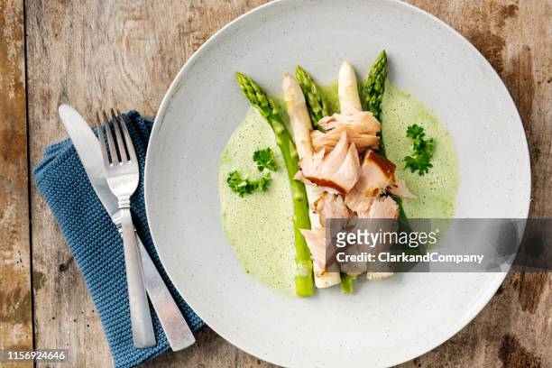 green and white asparagus with flaked salmon. - cooked asparagus stock pictures, royalty-free photos & images