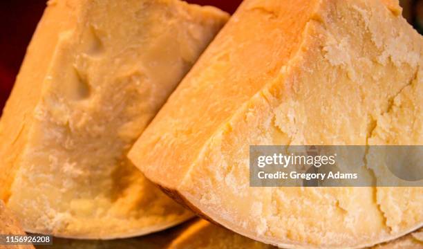 blocks of fresh parmesan cheese in tuscany italy - parmigiano foto e immagini stock