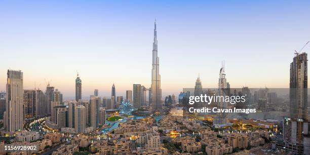 panoramic view of dubai skyline and burj khalifa under golden light - dubai burj khalifa stock pictures, royalty-free photos & images