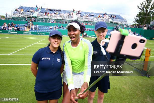 Venus Williams of the USA poses for a selfie with ballkids after victory in her first round match against Aliaksandra Sasnovich of Belarus during day...