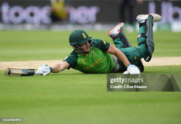 David Miller of South Africa dives to make his ground during the Group Stage match of the ICC Cricket World Cup 2019 between New Zealand and South...