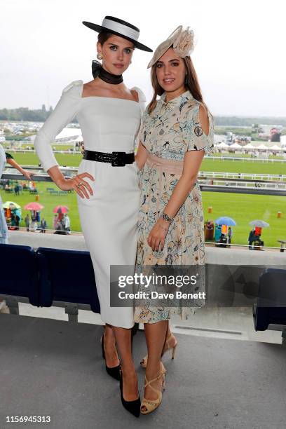 Sabrina Percy, wearing hat by Suzannah and Emily London and Amber Le Bon, wearing hat by Jane Taylor on day 2 of Royal Ascot at Ascot Racecourse on...