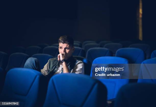 joven caucásico viendo películas en el cine y relajándose en tiempo libre - when we were young and afraid opening night fotografías e imágenes de stock