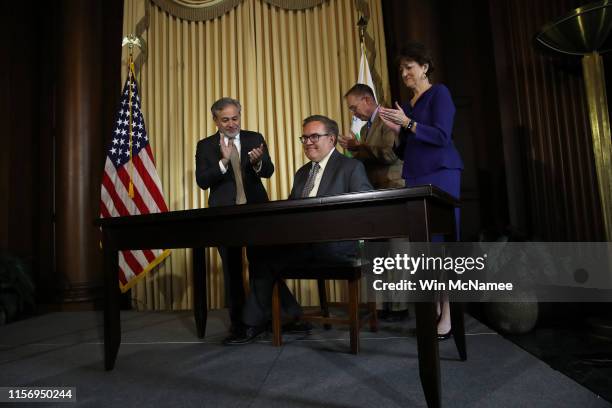 Environmental Protection Agency Administrator Scott Wheeler finishes signing the Affordable Clean Energy final rule at a ceremony at EPA headquarters...