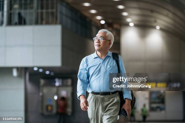 senior zakenman op reis - business man walking with a bag in asia stockfoto's en -beelden