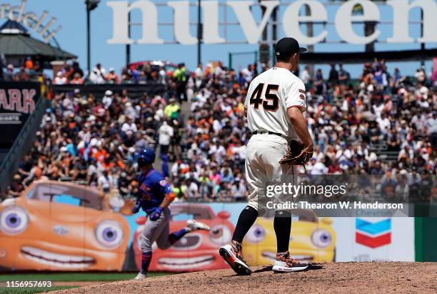 Pete Alonso of the New York Mets trots around the bases after hitting a pinch-hit three-run home run off of Derek Holland of the San Francisco Giants...