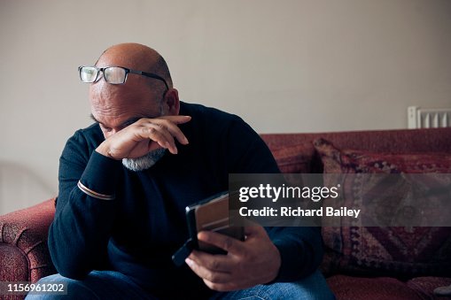 Indian Sikh man looking at mobile phone. Indian Sikh man looking at mobile phone.