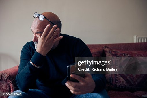 Indian Sikh man looking at mobile phone. Indian Sikh man looking at mobile phone.