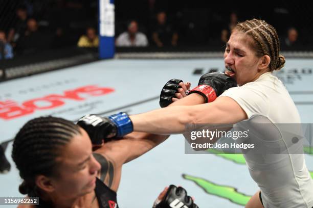 Raquel Pennington punches Irene Aldana of Mexico in their women's bantamweight bout during the UFC Fight Night event at AT&T Center on July 20, 2019...