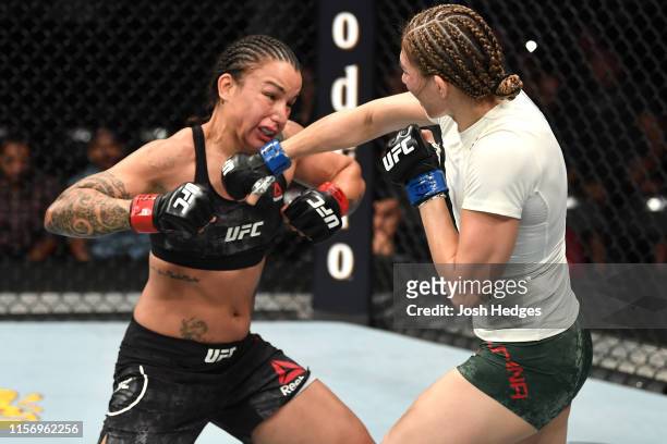 Irene Aldana of Mexico punches Raquel Pennington in their women's bantamweight bout during the UFC Fight Night event at AT&T Center on July 20, 2019...