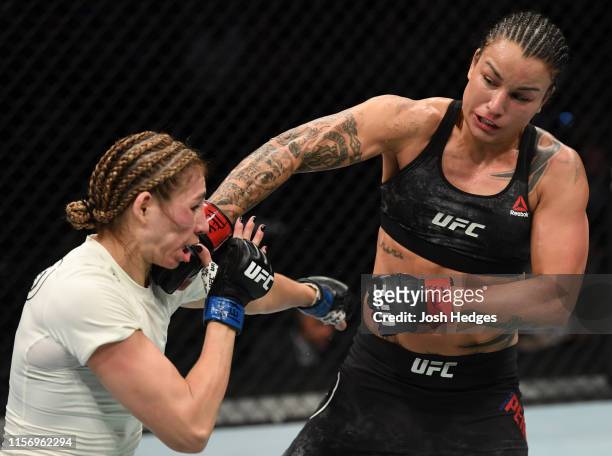Raquel Pennington punches Irene Aldana of Mexico in their women's bantamweight bout during the UFC Fight Night event at AT&T Center on July 20, 2019...