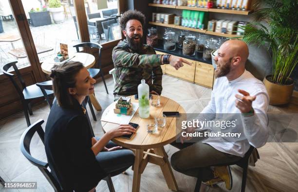 hipster group of people joking - round table imagens e fotografias de stock