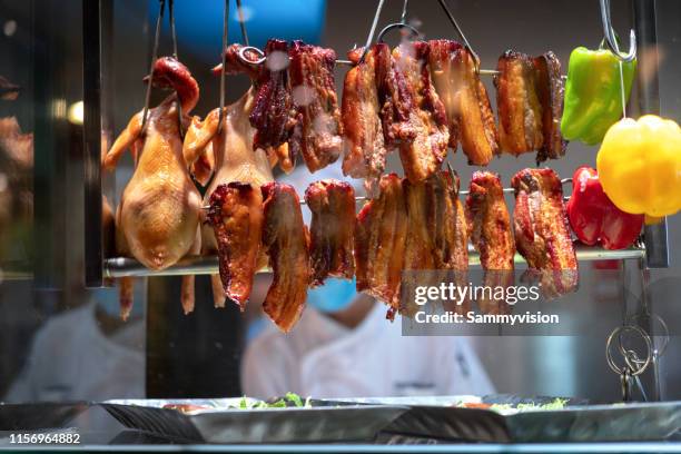 chinese traditional babecue pork and grilled chicken in the domestic kitchen - char siu pork stock-fotos und bilder