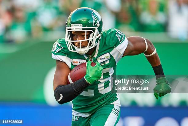 Loucheiz Purifoy of the Saskatchewan Roughriders runs with the ball after making an interception in the game between the BC Lions and Saskatchewan...