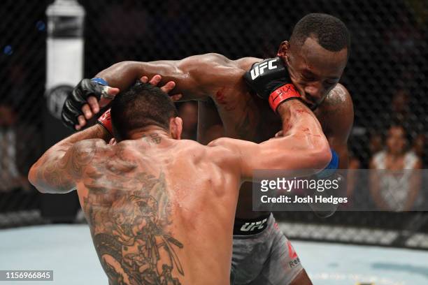 Rafael Dos Anjos of Brazil punches Leon Edwards of Jamaica in their welterweight bout during the UFC Fight Night event at AT&T Center on July 20,...