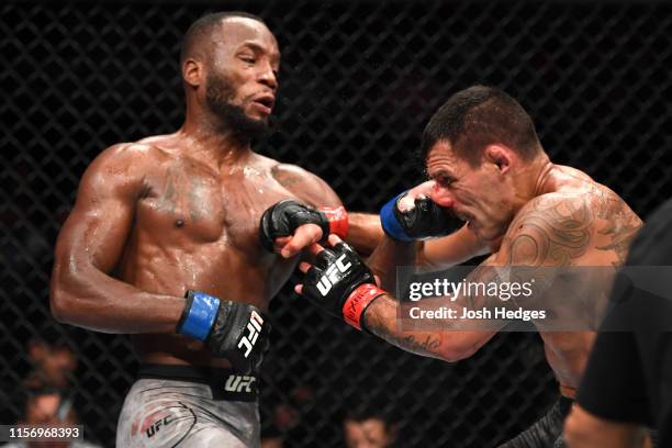 Leon Edwards of Jamaica punches Rafael Dos Anjos of Brazil in their welterweight bout during the UFC Fight Night event at AT&T Center on July 20,...