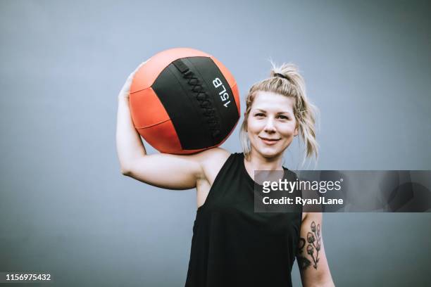 female trainer at cross training gym - medicine ball stock pictures, royalty-free photos & images