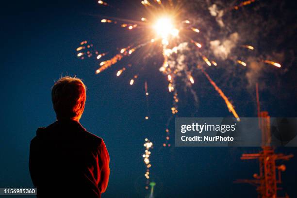 Spectators are backlit by the firework show during the Burnin the De'il bonfire event, on Caerlee Hill, during the annual St. Ronan's Festival, on...