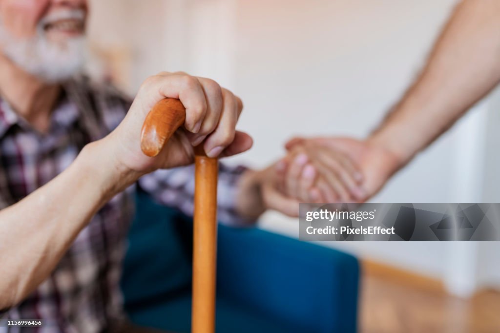 Home Caregiver Showing Support for Elderly Patient