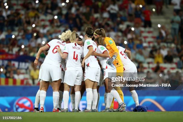 Players of England huddle on the pitch at half time of the 2019 FIFA Women's World Cup France group D match between Japan and England at Stade de...