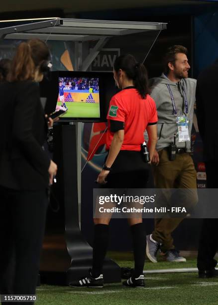 Referee Ri Hyang Ok checks VAR before awarding a penalty to Argentina during the 2019 FIFA Women's World Cup France group D match between Scotland...