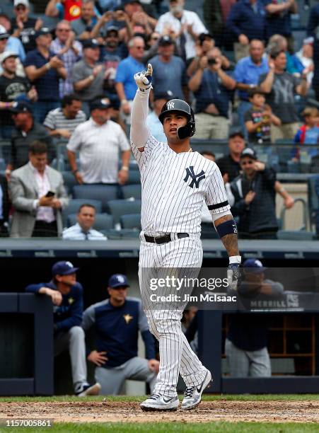 Gleyber Torres of the New York Yankees celebrates his seventh inning grand slam home run against the Tampa Bay Rays at home plate at Yankee Stadium...