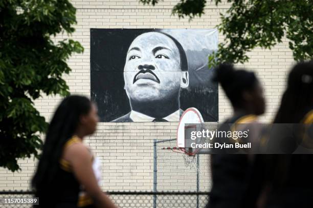 The parade passes by a painting of Martin Luther King Jr. During the 48th Annual Juneteenth Day Festival on June 19, 2019 in Milwaukee, Wisconsin.