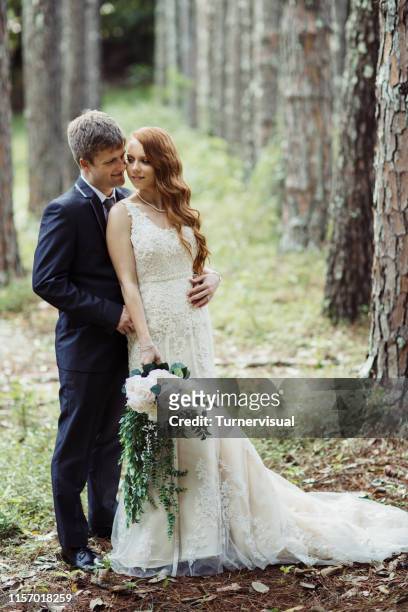 wedding couple embracing in forest - ginger bush stock pictures, royalty-free photos & images