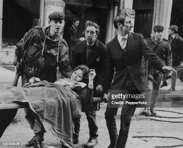 The victim of an IRA bomb blast which killed six and injured 146 is carried off on a stretcher on Donegall Street, Belfast, Northern Ireland on 21st...