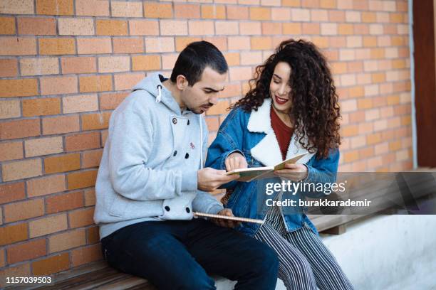 Two Students Comparing Notes Couple Comparing Notes Photos and Premium High Res Pictures - Getty Images