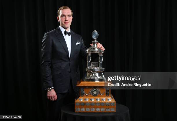 Andrei Vasilevskiy of the Tampa Bay Lightning poses for a portrait with the Vezina Trophy awarded to the goalkeeper adjudged to be the best at his...