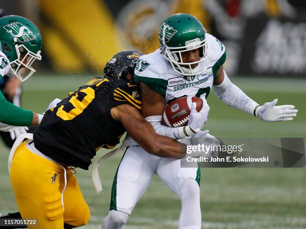 Jackson Bennett of the Hamilton Tiger-Cats goes to tackle Loucheiz Purifoy during a game at Tim Hortons Field on June 13, 2019. Hamilton defeated...