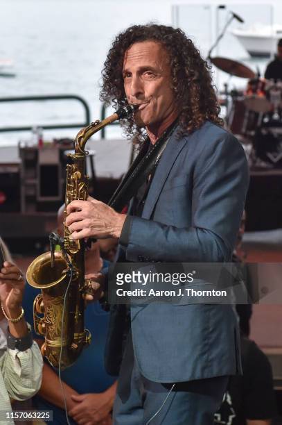Saxophonist Kenny G performs on stage at The Aretha Franklin Amphitheatre on June 19, 2019 in Detroit, Michigan.
