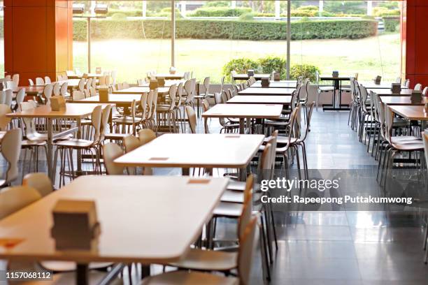 tables and chairs on food court shopping mall. food center in department store - cafeteria stock pictures, royalty-free photos & images