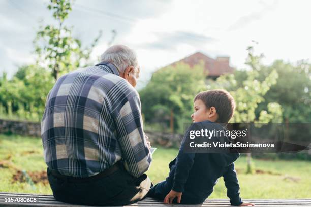 grandfather and grandchild outdoors. - wisdom stock pictures, royalty-free photos & images