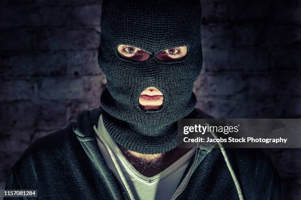 portrait of adult man wearing balaclava - balaclava stock pictures, royalty-free photos & images