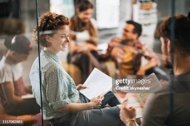 happy female university student talking to a friend while studying at campus. - test preparation stock pictures, royalty-free photos & images