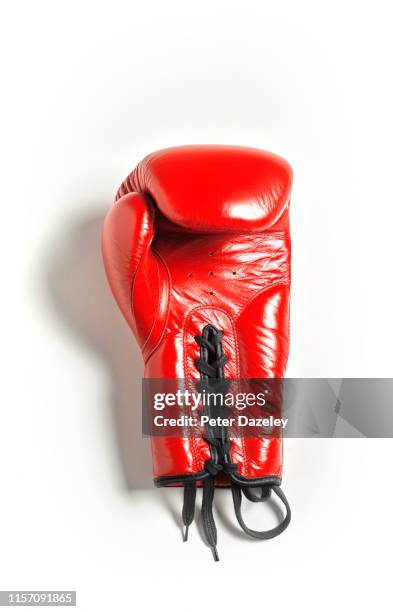 red boxing glove on white background - sport equipment stock pictures, royalty-free photos & images