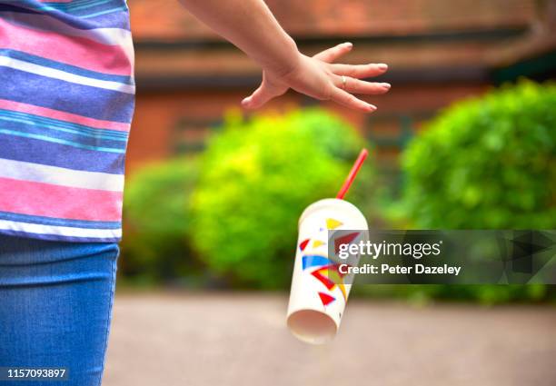 young student/teenager dropping litter - flip stock pictures, royalty-free photos & images