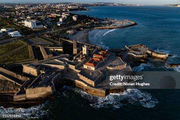 aerial flying over coastline looking at fort of são julião da barra in portugal - department of defense stock pictures, royalty-free photos & images