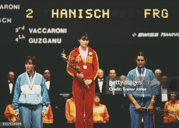 Jujie Luan of China celebrates winning the Women's Individual foil competition from silver medallist Cornelia Hanisch of Germany and bronze medallist...
