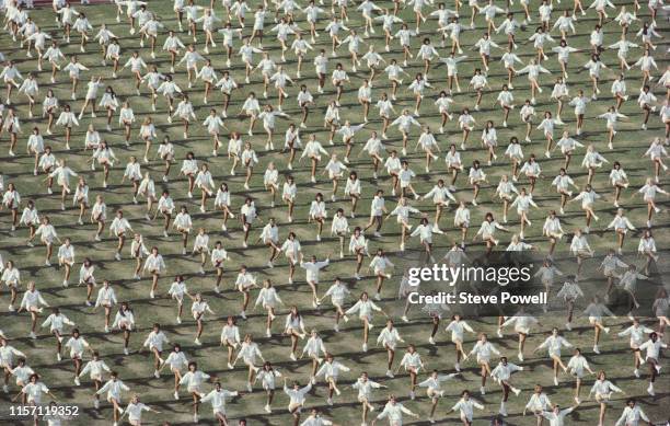 Mass dancers perform on the stadium infield during the opening ceremony for the XXIII Olympic Games on 28 July 1984 at the Los Angeles Memorial...