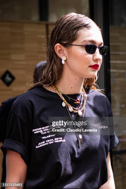 Gigi Hadid, wearing black sunglasses and black Off-White printed t-shirt, is seen outside Off-White fashion show on Day 2 during the Paris Fashion...