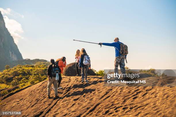tourist guide in (pedra do castelinho) in the serra dos orgãos national park, rio de janeiro, brazil - guidebook stock pictures, royalty-free photos & images